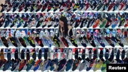 A customer shops for shoes at a mall in Hefei, Anhui province, March 10, 2015. China's annual consumer inflation recovered in February, exceeding expectations, but producer prices continued to slide, underscoring deepening weakness in the economy 