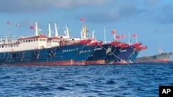 In this photo provided by the National Task Force-West Philippine Sea, Chinese vessels are moored at Whitsun Reef, South China Sea on March 27, 2021. The Philippine government said Wednesday, March 31, that more than 250 Chinese vessels it believes…