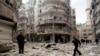 FILE -- Men inspect damage at site of barrel bomb attack by forces loyal to Syria's President Bashar al-Assad, al-Shaar neighborhood, Aleppo, February 26, 2015.