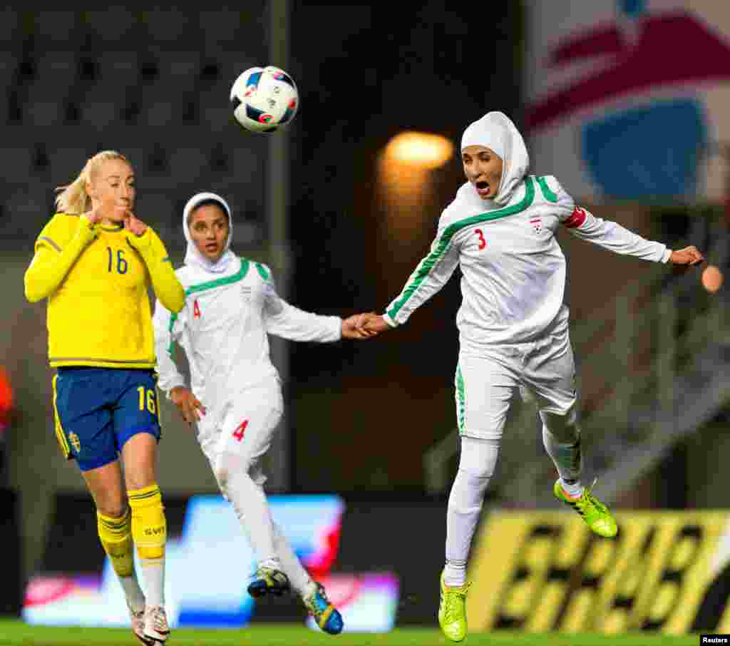 Iran's Koueistan Khosravi heads the ball in front of Sweden's Petra Andersson during the international friendly soccer match between Sweden and Iran at the Old Ullevi Soccer Stadium in Gothenborg, Sweden.