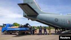 A supplied image of Australian Defence Force and Papua New Guinea Police Force personnel unloading ballot papers for the upcoming National Election, which runs from June 24 until July 8, from a C-27J Spartan aircraft in Papua New Guinea, June 15, 2017.