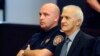 FILE - Dragan Vasiljkovic, right, a former Serb military commander sits between guards in a courtroom at the beginning of his trial in Split, Croatia, Sept. 20, 2016. Vasiljkovic is accused of overseeing the torture and murder of civilians and prisoners in Croatia in the early 1990s.