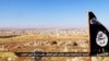 FILE - An image made available by propaganda Islamist media outlet Welayat Halab allegedly shows the trademark Jihadist flag positioned in the Mishtenur area, a plateau south of Kobani, Syria.