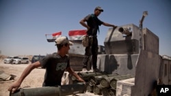 Iraqi counterterrorism forces load a Humvee with rockets to take to a front line position in their fight to oust Islamic State militants from Fallujah, Iraq, June 7, 2016.