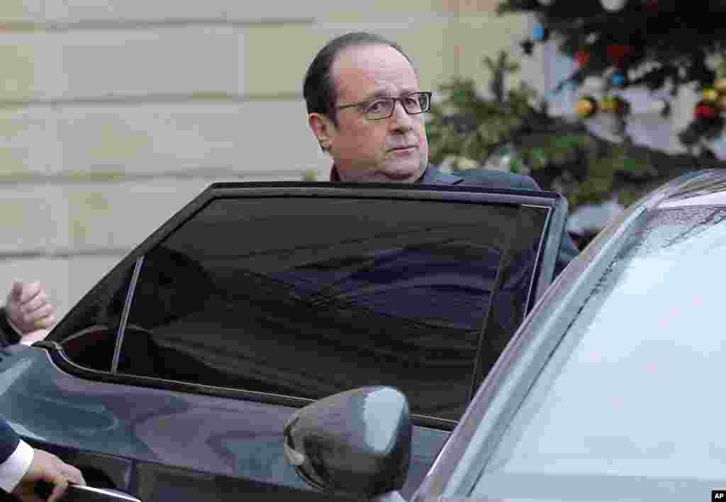 French President Francois Hollande leaves the Elysee Palace after a shooting at a French satirical weekly paper, in Paris, Jan. 7, 2015.