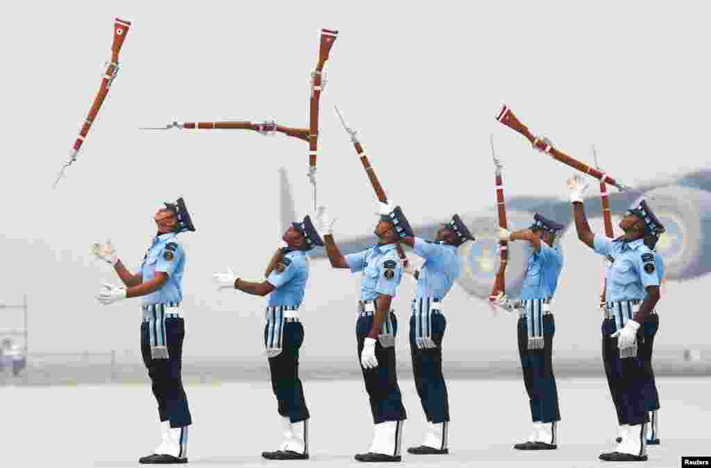 Indian Air Force soldiers toss their rifles during the full-dress rehearsal for Indian Air Force Day at the Hindon air force station on the outskirts of New Delhi.