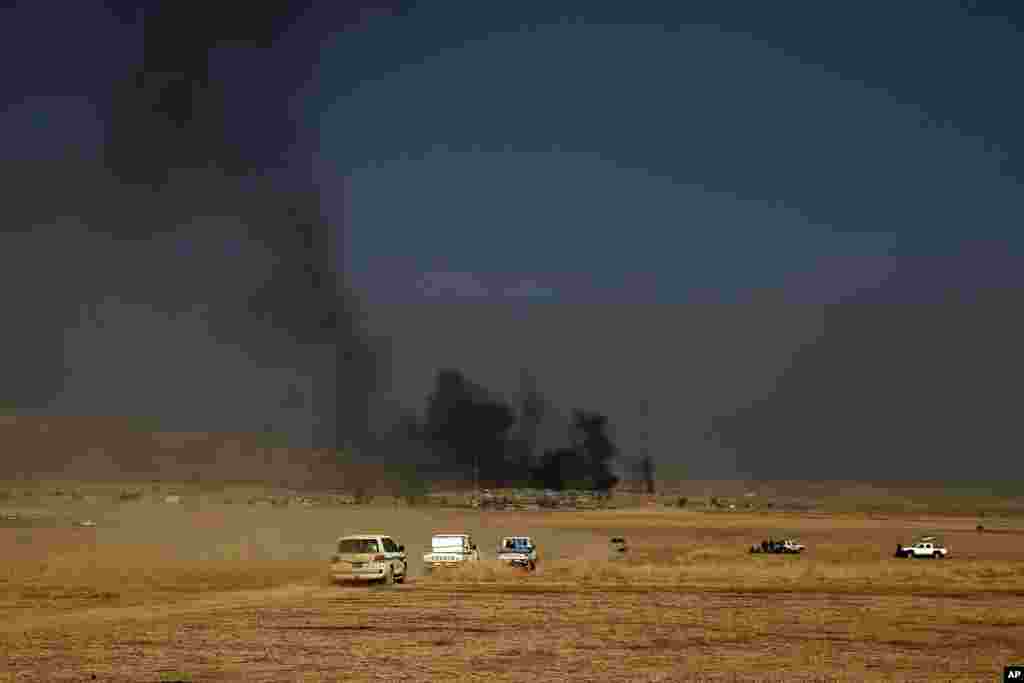 A peshmerga convoy drives towards a frontline in Khazer, about 30 kilometers east of Mosul. The Iraqi military and the country's Kurdish forces say they launched operations to the south and east of militant-held Mosul early Monday morning.