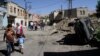 FILE - People walk in a street of Silvan district in Diyarbakir after clashes between Turkish army and Kurdish rebels, Aug. 19, 2015.