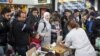 Volunteers distribute food and drinks to migrants who arrived at Malmo train station in Sweden on the morning of Sept. 10, 2015. 