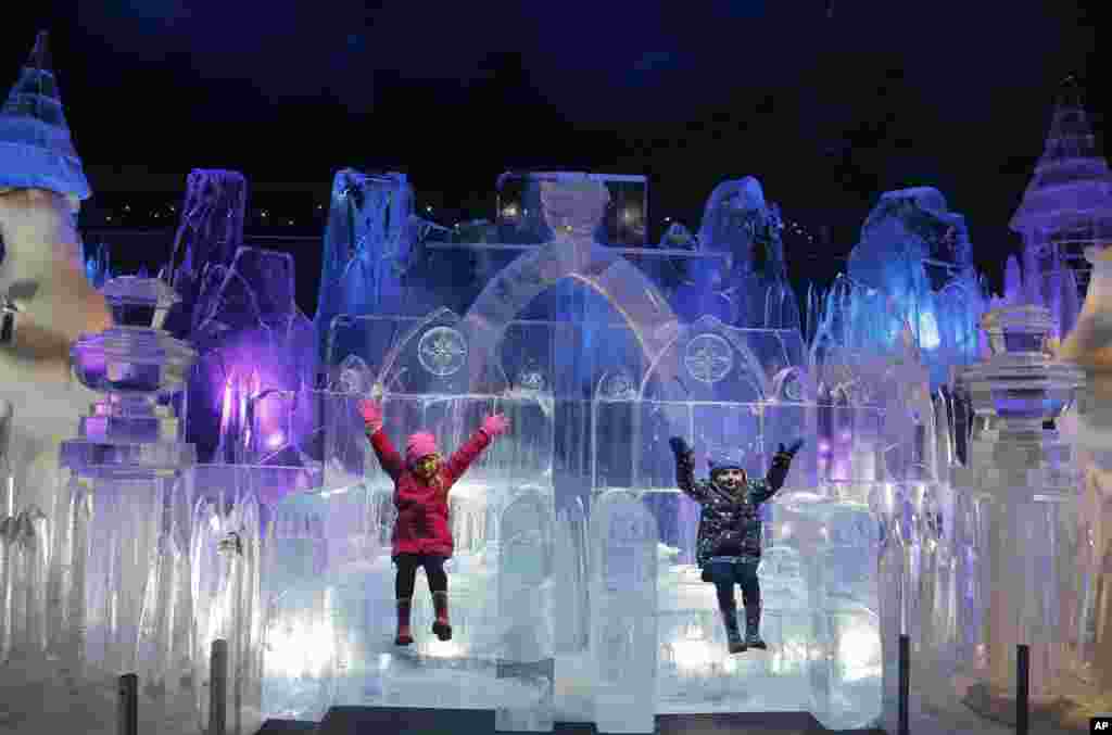 Scarlett, 4, left, and Zoe, 3, enjoy sitting on a Throne of the castle ice sculpture at the launch of Hyde Park Winter Wonderland's Magical Ice Kingdom in London.