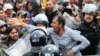A migrant man reacts as he is surrounded by Slovenian police at the Slovenia-Croatia border crossing in Rigonce, Slovenia, Sept. 19, 2015. 