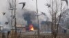 Flames and smoke billows from a residential building where militants are suspected to have taken refuge during a gun battle in Pulwama, south of Srinagar, Indian controlled Kashmir, Monday, Feb. 18, 2019. 
