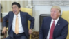 At the end of a long handshake with President Donald Trump in the Oval Office at the White House, Japanese Prime Minister Shinzo Abe planted his hands into the armrests of his chair as he looked away, Feb. 10, 2017.