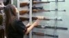 Salesperson Lauren Ungari checks rifles in a display in a gun shop in Sydney, Australia, Oct. 4, 2017. Australia recently concluded a three-month gun amnesty period that collected more than 51,000 guns.