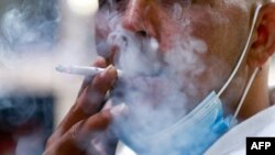 A Jordanian man smokes a cigarette in the capital Amman, on March 17, 2021. - With already one of the world's highest rates of smokers, 