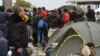 Many of the masses of migrants from the Middle East and Africa, like these in Opatovac, Croatia, escaped extremist groups and are traveling in search of what they call "normal lives." (VOA / H. Murdock)