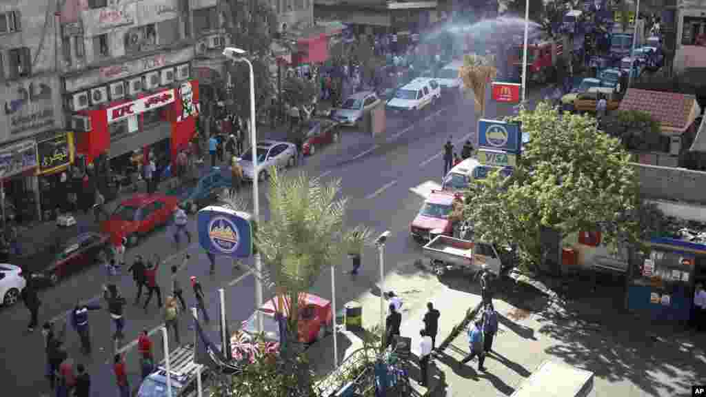 Police fire a water cannon to disperse a protest by dozens of activists commemorating the death of a protester a year earlier, Cairo, Nov. 26, 2013.