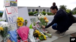 A woman leaves flowers on a growing memorial across the street from the Chabad of Poway synagogue in Poway, California, April 29, 2019. 