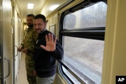 Presiden Ukraina Volodymyr Zelenskyy melambaikan tangannya usai wawancara dengan The Associated Press di atas kereta api yang melaju dari wilayah Sumy menuju Kyiv, Ukraina, Selasa 28 Maret 2023. (AP/Efrem Lukatsky)