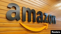 FILE - The logo of Amazon is pictured inside the company's office in Bengaluru, India, Apr. 20, 2018. 