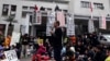 A professor speaks to students during a protest outside Taiwan&#39;s legislature in Taipei, March 20, 2014. Hundreds of protesters in Taiwan opposed to a trade pact with China which they fear gives the mainland too much economic influence and access to opport