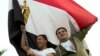 Supporters of President Abdel-Fattah el-Sissi wave a national flag as they celebrate in Mustafa Mahmoud Square after the election commission announced the presidential election results, in Cairo, April 2, 2018. The commission said el-Sissi has won a second, four-year term with more than 97 percent of the vote in last week's election, with turnout of 41.05 percent. 