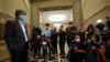 FILE - Steven Gan, left, editor-in-chief of Malaysiakini online news portal, arrives at court in Putrajaya, Malaysia, July 13, 2020. 