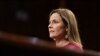 U.S. Supreme Court nominee Judge Amy Coney Barrett reacts as she sits in front of her children and her husband Jesse Barrett during the second day of her confirmation hearing before the Senate Judiciary Committee on Capitol Hill in Washington, D.C.