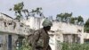 A Ugandan African Union peacekeeper patrols an empty street in the Wardigley district of southern Mogadishu, August 7, 2011